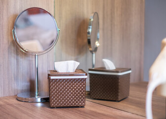 box of tissues placed next to a modern mirror on the vanity in the resort.