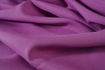 Close-up of purple wave background fabric. Blurred image.