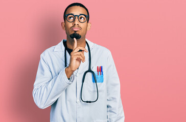 Young african american man wearing doctor uniform and stethoscope thinking concentrated about doubt...