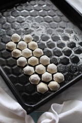 raw frozen dumplings on a black dish