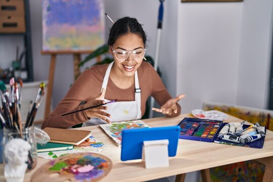Young african american woman artist having online draw class at art studio