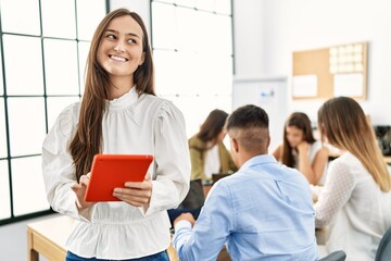 Group of business workers working sitting on the table. Woman smiling happy and using touchpad standing at the office.