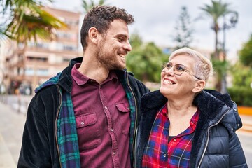 Fototapeta premium Mother and son smiling confident hugging each other at park