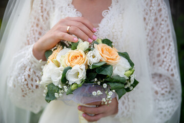 the bride in a white dress holds a bouquet of bloom flowers in her hands. idea for wedding event agencies