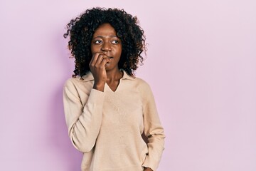 Fototapeta na wymiar Young african american woman wearing casual clothes looking stressed and nervous with hands on mouth biting nails. anxiety problem.