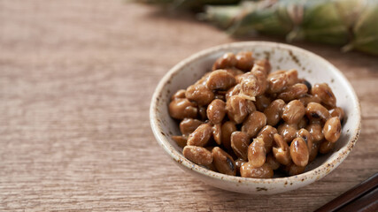 close up Natto or Fermented Soybean in a bowl on the wooden background. Japanese food                                                                              