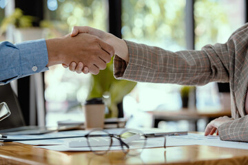 Professional Business partner handshake after planing planning and presentation project at meeting working and analysis at workspace, financial and handshake concept to congratulate.