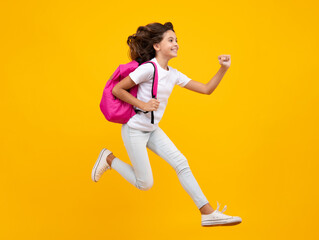 Fototapeta na wymiar Schoolgirl with backpack. Teenager student, isolated background. Learning and knowledge. Go study. Crazy run and jump. Children education concept. Back to school.