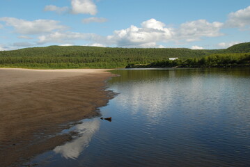 Fototapeta premium A sand beach by the Karasjok river on sunny day, Finnmark, Norway