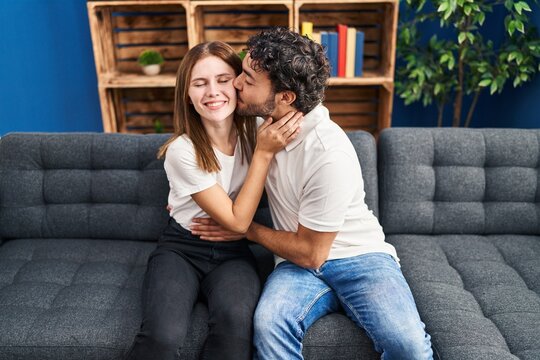 Man and woman kissing and hugging each other at home