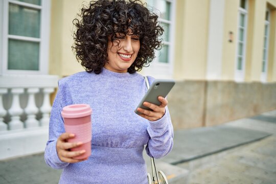Young middle east woman smiling confident using smartphone at street