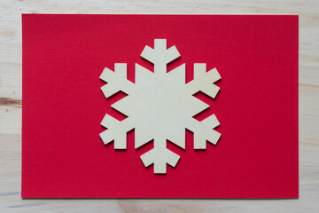 wooden snowflake ornament on paper