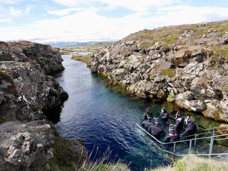 Scuba diving at Silfra rift, where Eurasian and American tectonic plate are divided in Thingvellir...