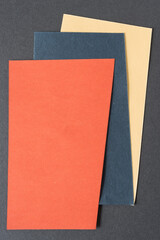 orange, blue, and yellow paper on gray
