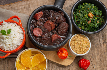 FEIJOADA: typical and traditional food of Brazilian cuisine, served with rice, farofa, orange, pepper and cabbage