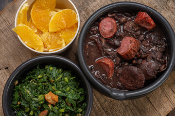 FEIJOADA: typical and traditional food of Brazilian cuisine, served with rice, farofa, orange, pepper and cabbage