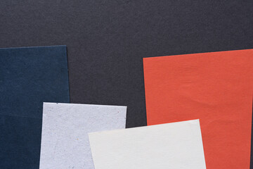 Fototapeta premium gray space with paper cards in blue, orange, and white