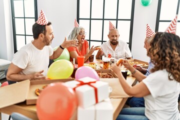 Group of middle age friends smiling happy celebrate birthday at home.