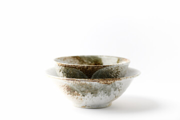 Traditional ceramic bowls on bright paper background. Soft focus. Close up. Copy space. 