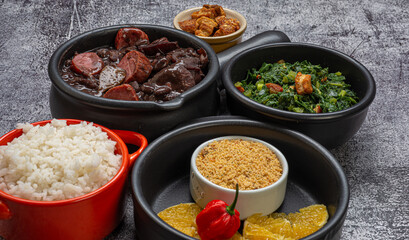 FEIJOADA: typical and traditional food of Brazilian cuisine, served with rice, farofa, orange, pepper and cabbage