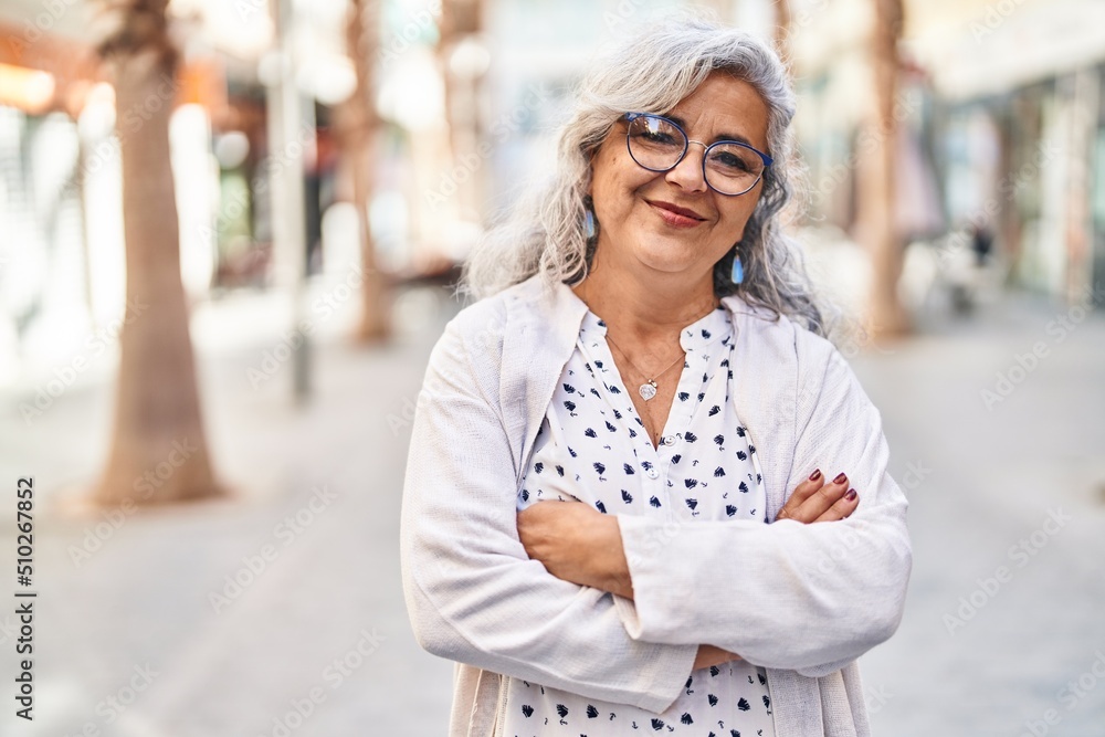 Poster Middle age woman smiling confident standing with arms crossed gesture at street