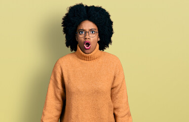 Fototapeta na wymiar Young african american woman wearing casual clothes scared and amazed with open mouth for surprise, disbelief face