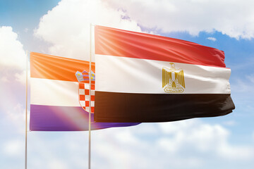 Sunny blue sky and flags of egypt and croatia