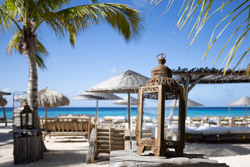 Vintage lantern on a tropical beach club background.