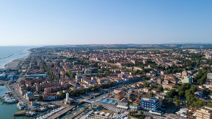 Fototapeta na wymiar Italy, June 2022; aerial view of Fano with its sea, beaches, port, umbrellas in the marche region