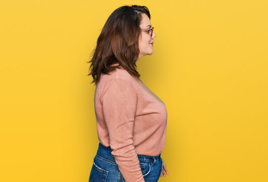 Young plus size woman wearing casual clothes and glasses looking to side, relax profile pose with natural face and confident smile.