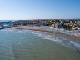Fototapeta premium Italy, June 2022; aerial view of Fano with its sea, beaches, port, umbrellas