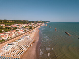 Naklejka na ściany i meble Italy, June 2022; aerial view of Fano with its sea, beaches, port, umbrellas