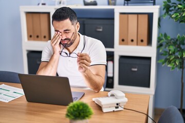 Young hispanic man business worker stressed working at office