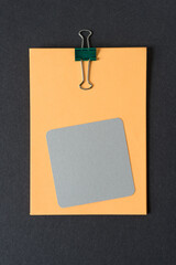 paper with clip and a gray square