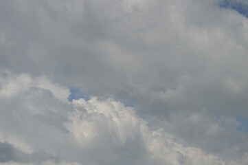 Large puffy white clouds on clear blue sky	