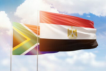 Sunny blue sky and flags of egypt and south africa