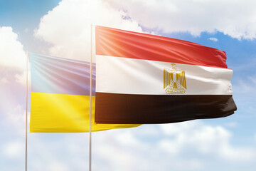 Sunny blue sky and flags of egypt and ukraine