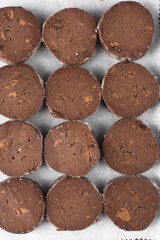 Chocolate palet breton cookies, chocolate sable cookies, french chocolate butter cookies, raw palet breton cookies sliced and placed on a parchment lined baking sheet 
