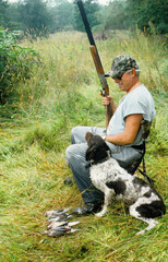 A hunter and his dog waiting for more doves