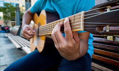 Obraz premium The hands of a guy playing guitar