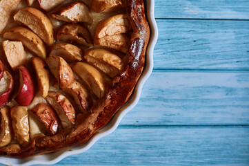 apple pie fresh pastries with apples red apples on a blue background white dishes