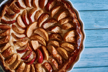 apple pie fresh pastries with apples red apples on a blue background white dishes