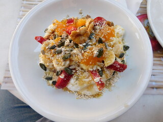 Yogurt with fruit and nuts, served as breakfast