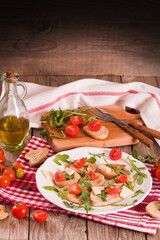 Friselle with cherry tomatoes and arugula.