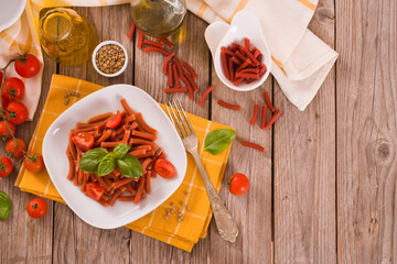 Lentil pasta with cherry tomatoes and basil.
