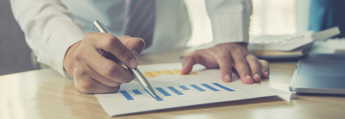 Male investment businessman has analyzed the market of the stock graph and evaluated the financial...