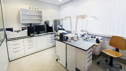 dental technician workplace with various equipment and furniture
