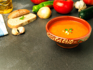 Cold Spanish soup Homemade Gazpacho served in a bowl with vegetables around it