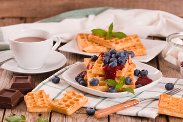 Waffles with blueberries and jam. 