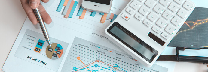 Financial businessman analyze the graph of the company's performance to create profits and growth,...
